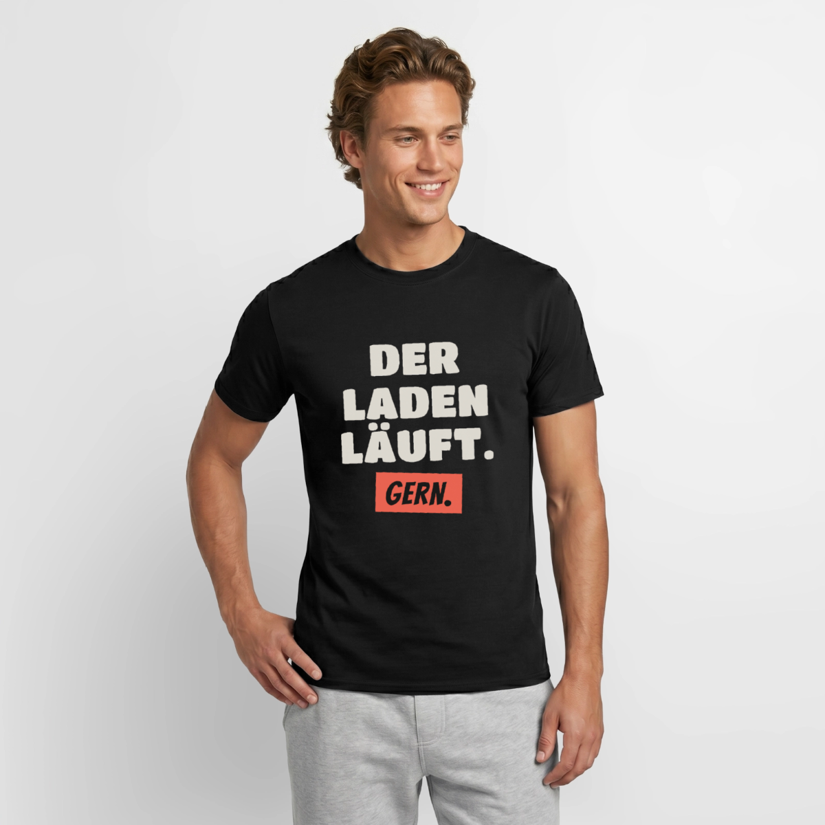 "Der Laden läuft. Gern." Motiv-T-Shirt für Männer, Farbe Schwarz, Model
