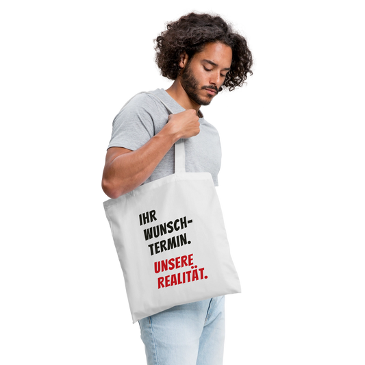 "Ihr Wunschtermin. Unsere Realität." Stoffbeutel, Farbe Weiß